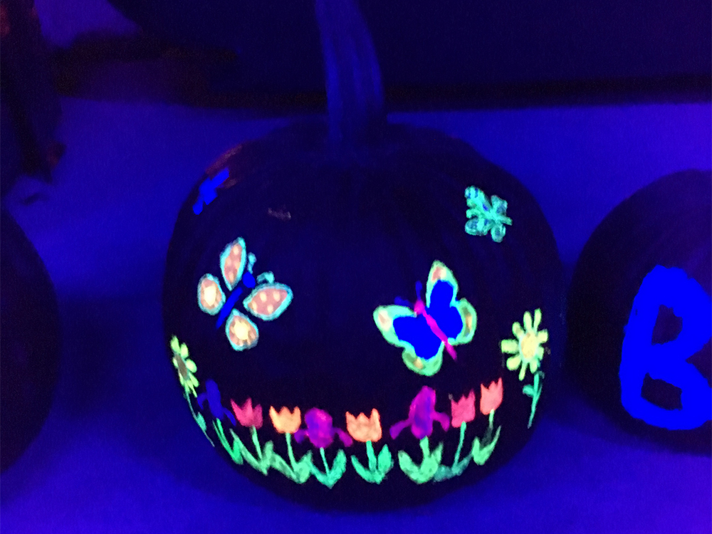 blacklight glowing pumpkin with butterflies