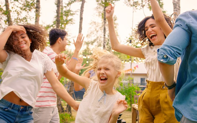a group of children and adults dancing